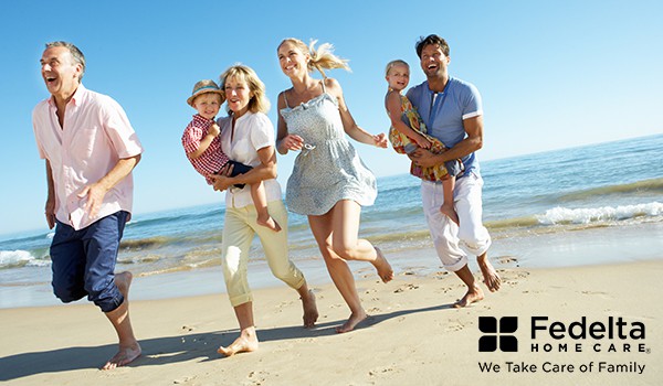 a family happily runs on the beach in the summer