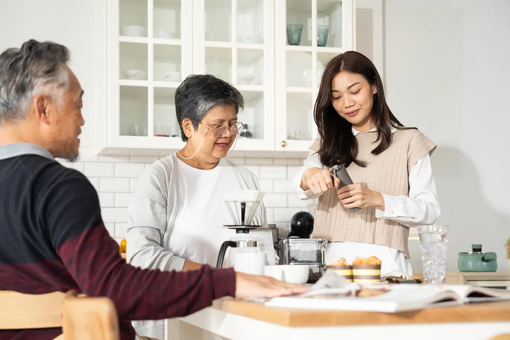 family in kitchen making coffee together