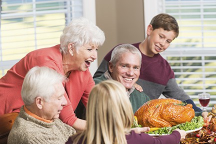 Senior woman serving roasted turkey
