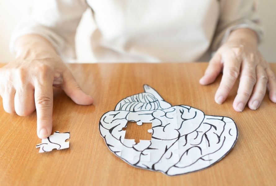 a senior completes a brain puzzle to symbolize activities that are good for seniors