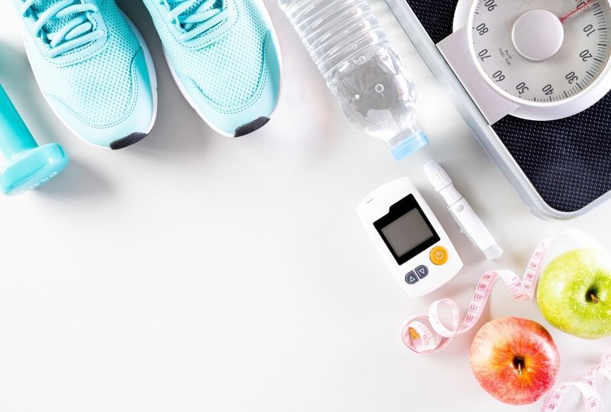 athletic shoes, water bottle, blood sugar monitor, apples