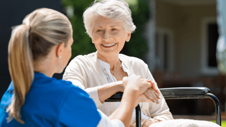 an in-home caregiver talks with an elderly women outdoors