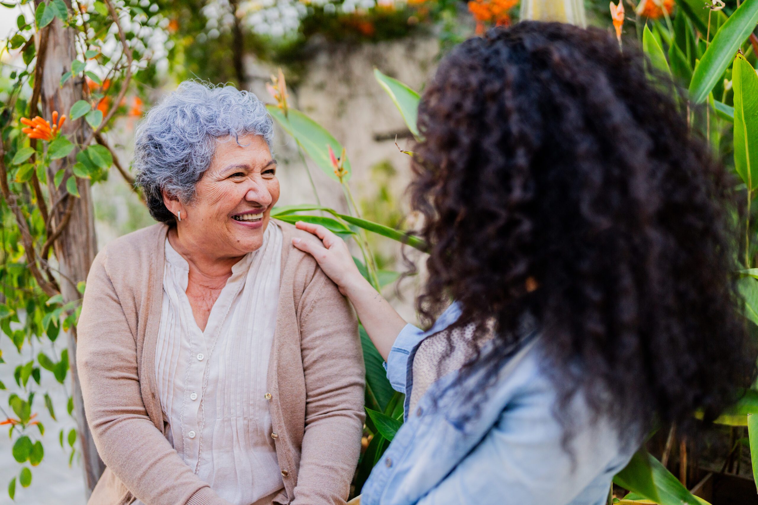 Mid adult woman talking to mother outdoors