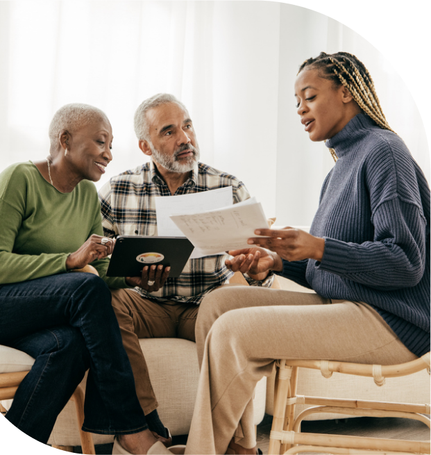 young woman discusses paperwork with aging parents