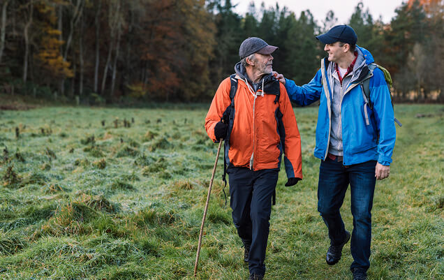 man and caregiver hiking