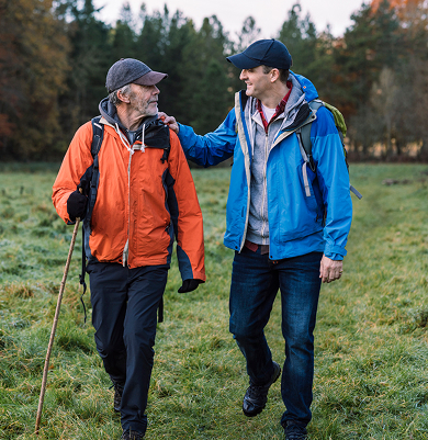 man and caregiver hiking