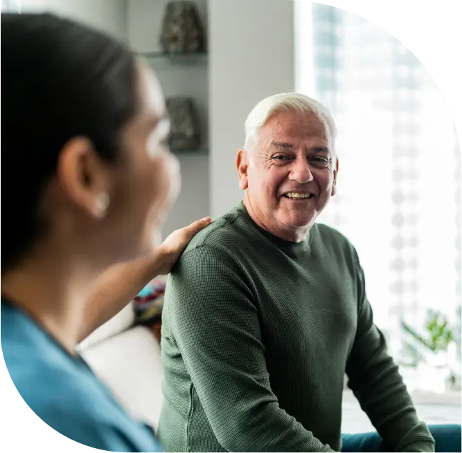 senior man smiles at caregiver